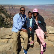 Family posing at the Grand Canyon South Rim on a guided tour.